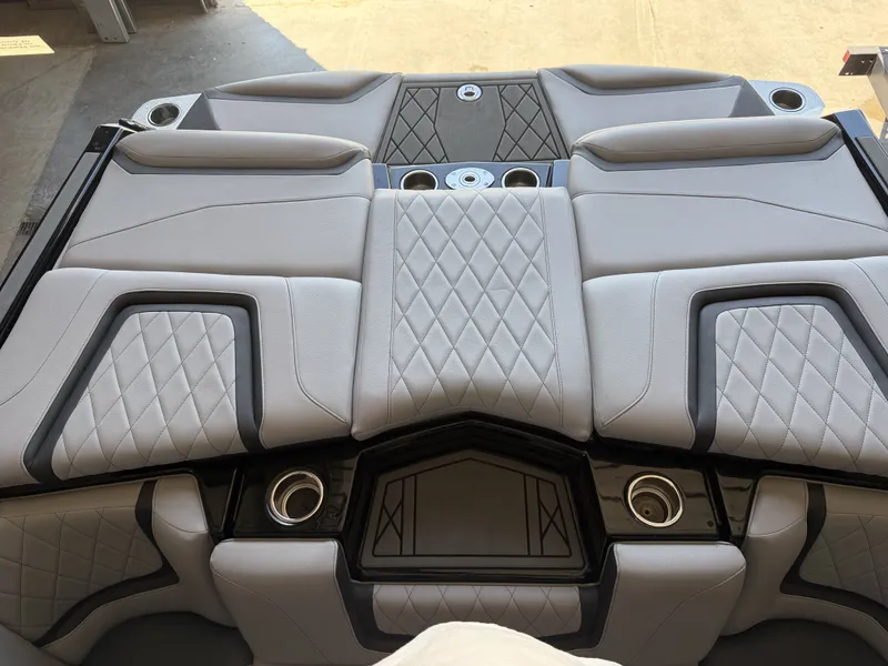 Slide: The Image of The image shows the luxurious stern of a 2021 Tigé 23ZX boat with cushioned seating. - 16