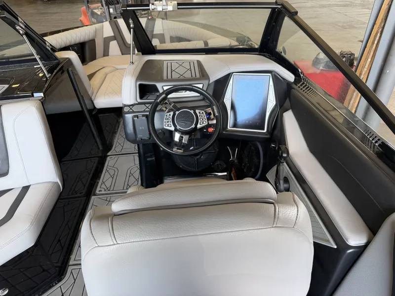 Slide: The Image of Interior of a 2021 Tigé 23ZX with modern steering wheel and large touchscreen display. - 30