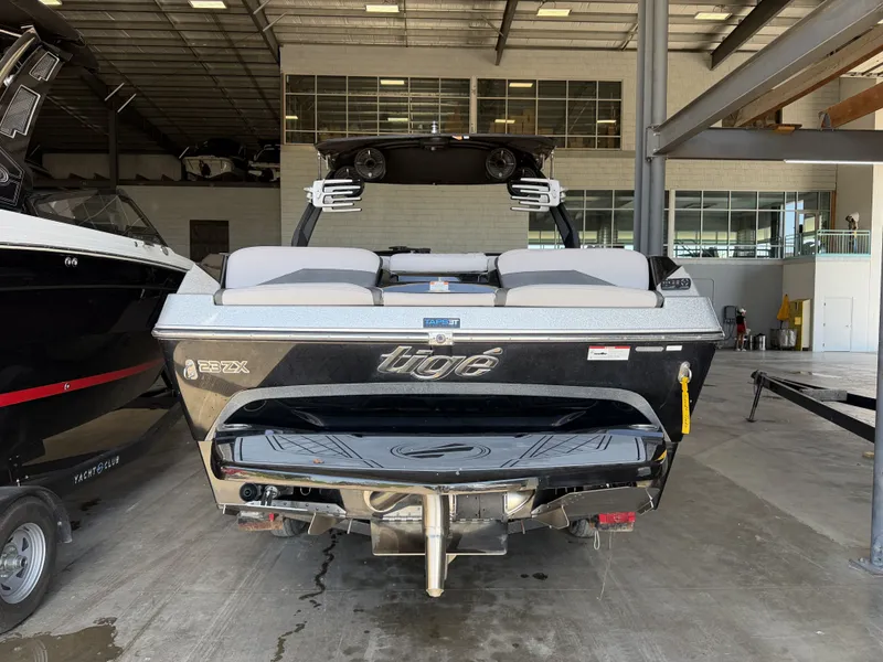 Slide: The Image of The image shows a 2021 Tigé 23ZX boat in a storage facility. - 7