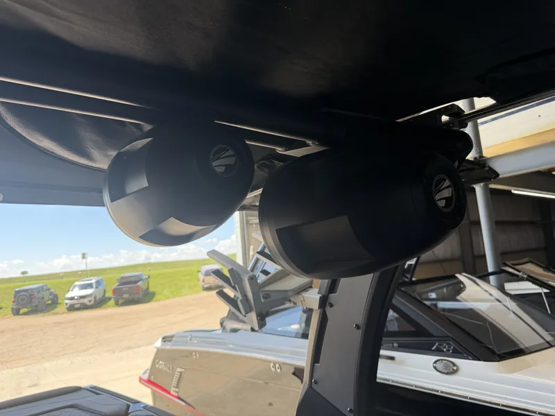 Slide: The Image of Two speakers are mounted under a boat canopy, with another boat visible in the background. - 45