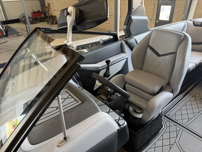 Slide: The Image of Interior of a 2021 Tigé 23ZX with gray leather seats and a modern helm. - 28