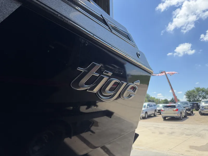Slide: The Image of Close-up of Tigé 23ZX boat hull with logo, parked outdoors. - 9