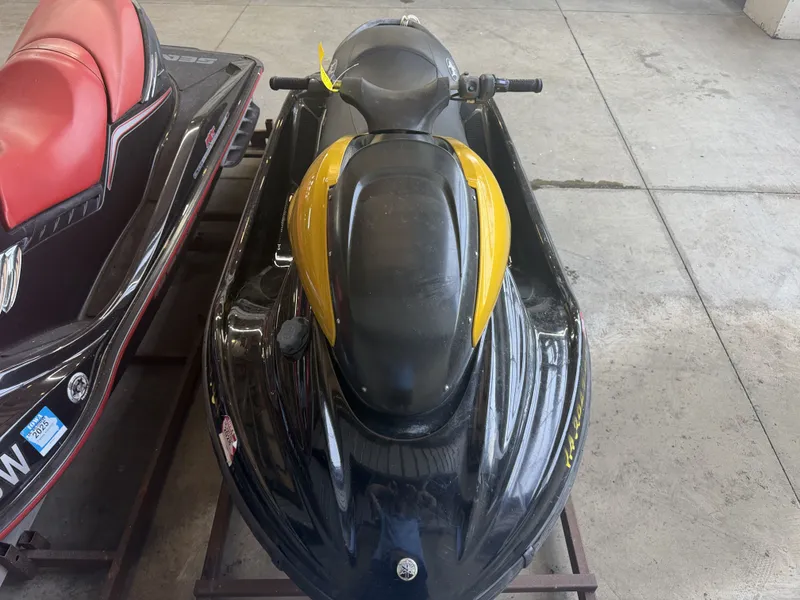 Slide: The Image of A black and yellow 2006 Yamaha GP1300R jet ski sits on a metal stand. - 9