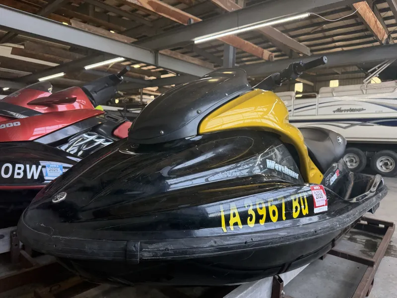 Slide: The Image of A yellow and black 2006 Yamaha GP1300R jet ski is stored in a warehouse. - 2