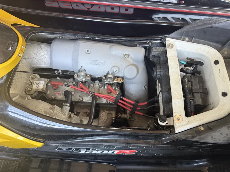 Slide: The Image of A 2006 Yamaha GP1300R jet ski with an open engine compartment showing the engine and wiring. - 17
