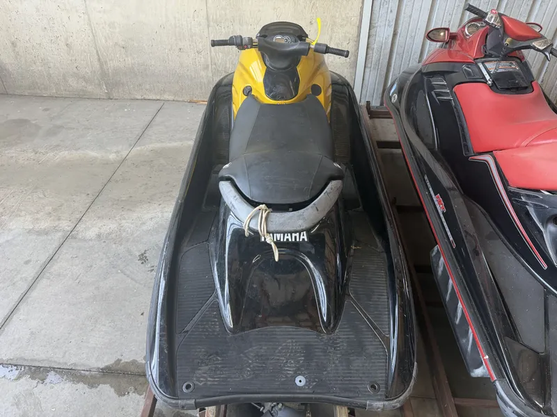 Slide: The Image of A yellow and black 2006 Yamaha GP1300R jet ski is parked in a storage area. - 11