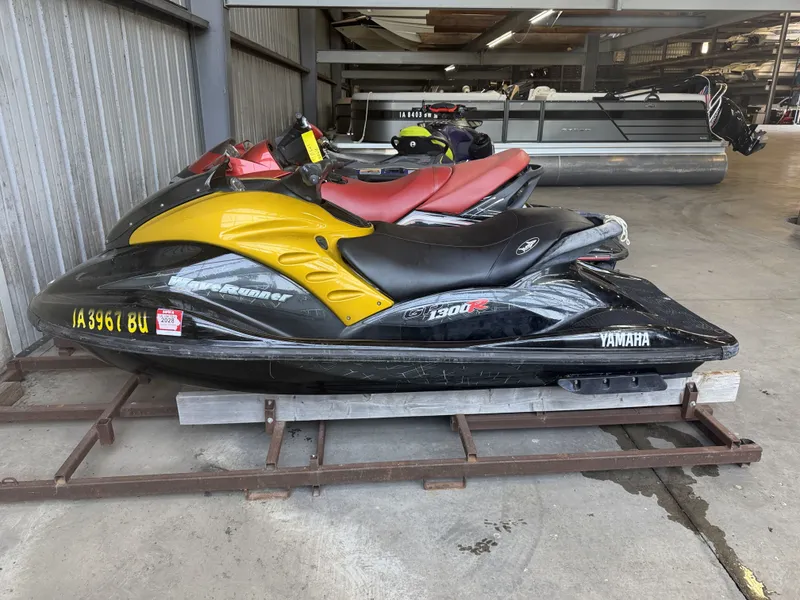 Slide: The Image of A 2006 Yamaha GP1300R jet ski with yellow and black accents is in a storage facility. - 4