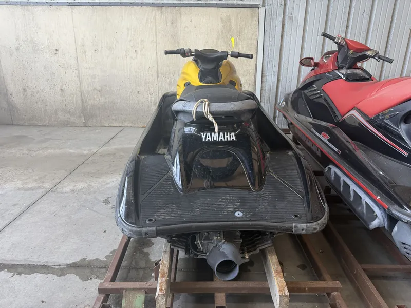 Slide: The Image of A 2006 Yamaha GP1300R jet ski is parked in a storage area next to a red jet ski. - 10