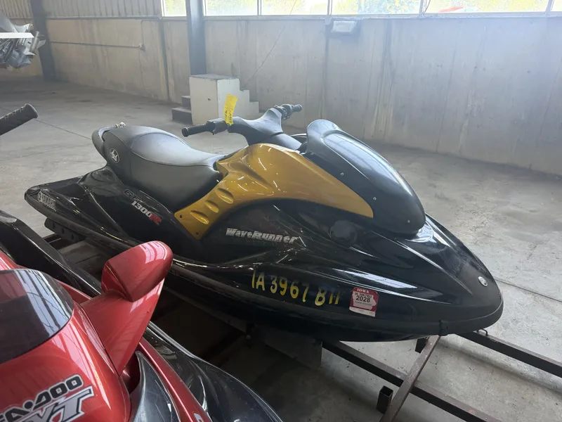 Slide: The Image of A 2006 Yamaha GP1300R jet ski in a storage area, featuring yellow and black accents. - 8