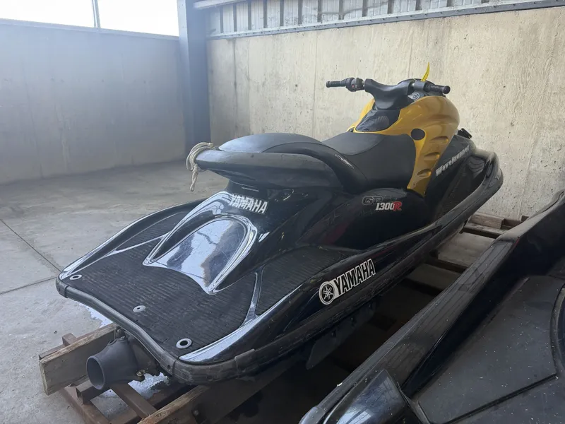 Slide: The Image of A black Yamaha GP1300R jet ski from 2006 is parked in a garage. - 6