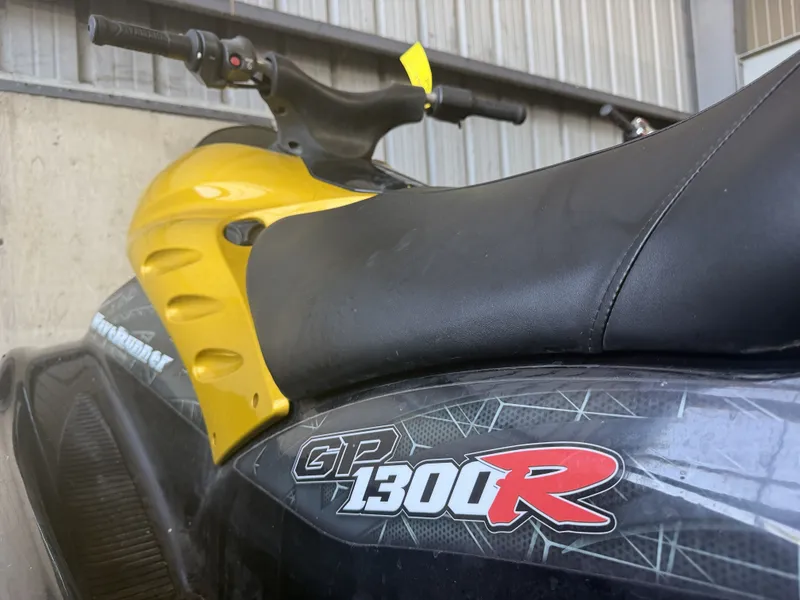 Slide: The Image of Close-up of a yellow 2006 Yamaha GP1300R jet ski parked in a garage. - 13
