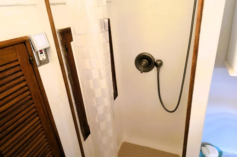Slide: The Image of 1978 Roughwater 41 twin cabin shower with wooden accents and modern fixtures. - 9