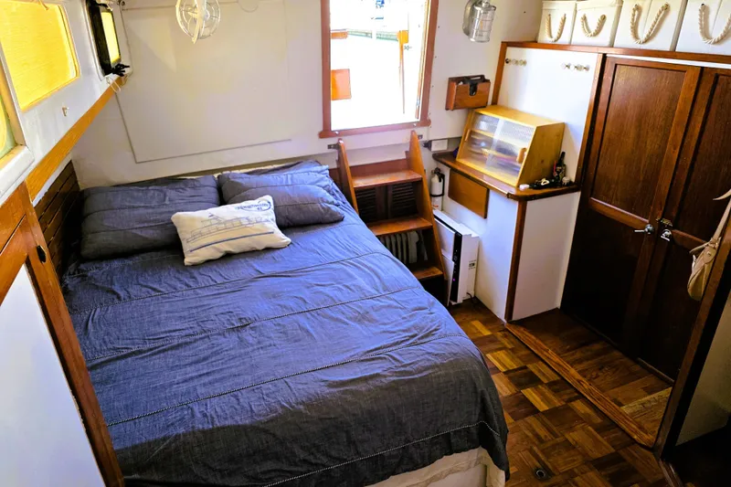 Slide: The Image of Cozy cabin interior of 1978 Roughwater 41 twin cabin boat with bed and wooden furnishings. - 7