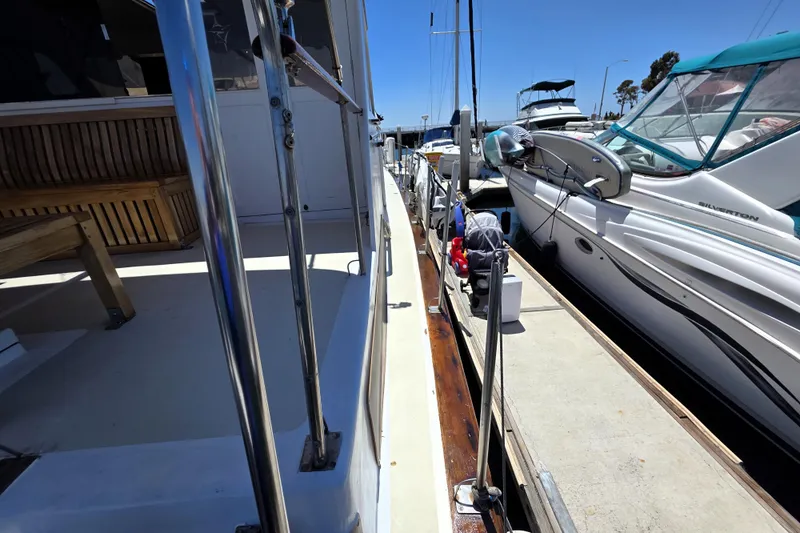 Slide: The Image of 1978 Roughwater 41 Twin Cabin yacht docked beside other boats in a marina. - 22