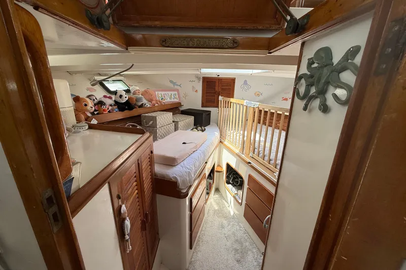 Slide: The Image of 1978 Roughwater 41 twin cabin interior with plush toys and nautical decor. - 16