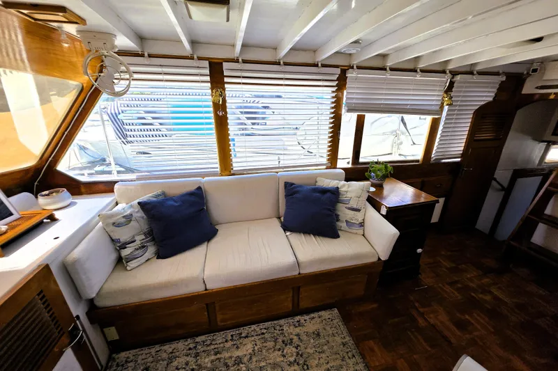 Slide: The Image of Interior of 1978 Roughwater 41 twin cabin with cozy seating and nautical decor. - 2