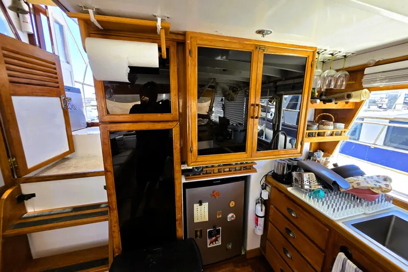 Slide: The Image of Interior of 1978 Roughwater 41 twin cabin with kitchen amenities and wooden cabinetry. - 31