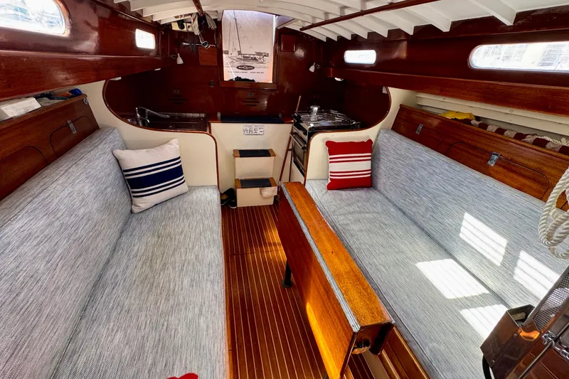 Slide: The Image of Interior of a 1955 Henry R Hinckley Owens Cutter sailboat with cozy seating and nautical decor. - 7