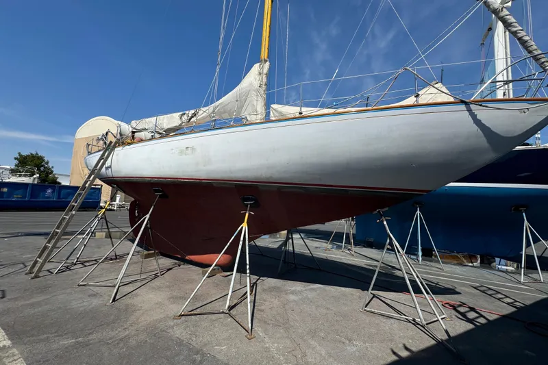 Slide: The Image of 1955 Henry R Hinckley Owens Cutter sailboat on stands in a boatyard. - 23