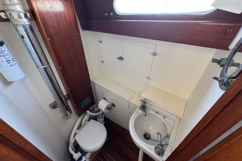 Slide: The Image of 1955 Henry R Hinckley Owens Cutter boat bathroom with sink and toilet. - 13