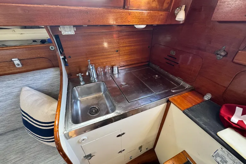 Slide: The Image of 1955 Henry R Hinckley Owens Cutter galley with wooden cabinetry and stainless steel sink. - 11