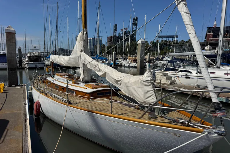 Slide: The Image of Vintage 1955 Henry R Hinckley Owens Cutter sailboat docked in a marina, showcasing classic design. - 24