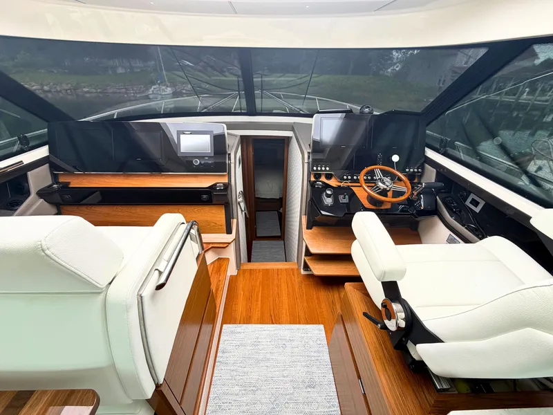 Slide: The Image of Interior of the 2025 Tiara Yachts 48 LE with modern navigation systems and luxurious seating. - 10