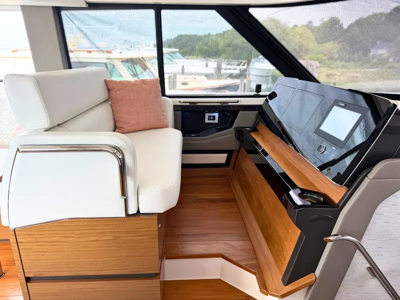 Slide: The Image of Interior of a 2025 Tiara Yachts 48 LE with sleek seating and modern helm console. - 14