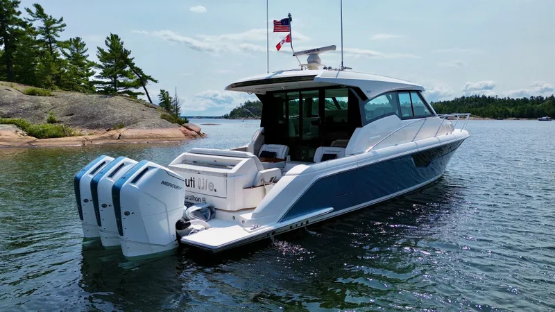Slide: The Image of A luxury yacht with three outboard engines anchored in calm waters. - 4