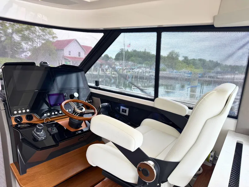 Slide: The Image of Interior view of a modern boat helm with white seats and high-tech controls. - 12