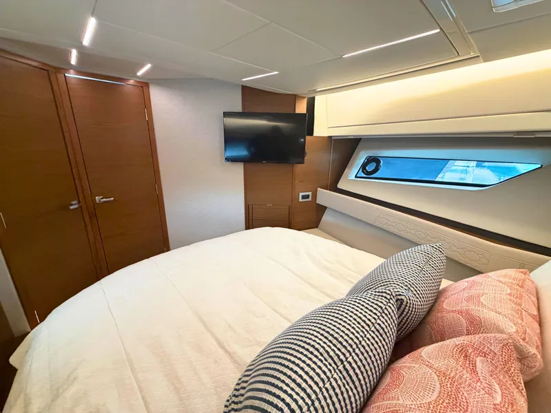 Slide: The Image of Cabin of the 2025 Tiara Yachts 48 LE with bed and window. - 22
