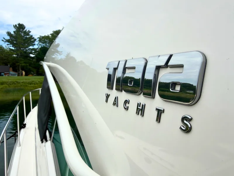 Slide: The Image of Close-up of the 2025 Tiara Yachts 48 LE, docked by the water. - 31