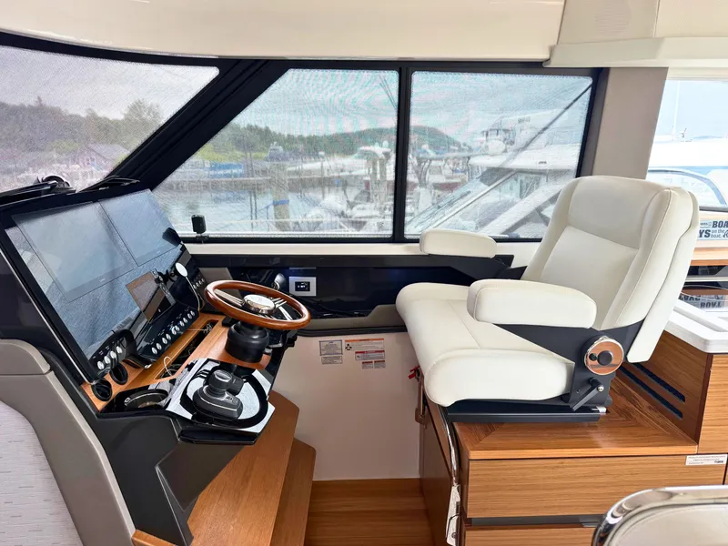 Slide: The Image of Interior view of a modern boat helm with a luxurious white captain's chair and wooden dashboard. - 11