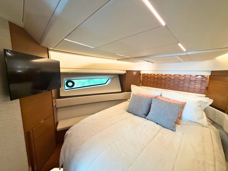 Slide: The Image of Luxurious cabin with a large bed, sleek lighting, and a flat-screen TV. - 20