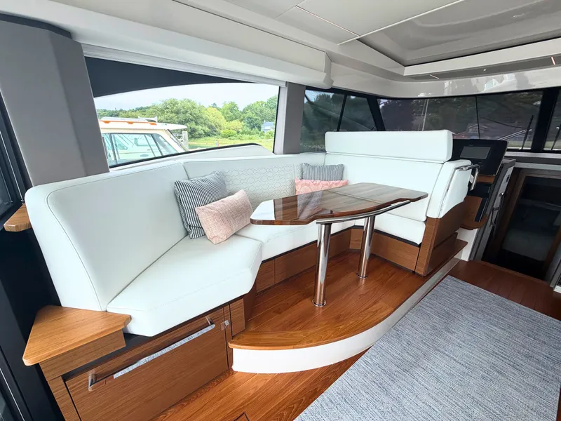 Slide: The Image of Interior of a Tiara Yachts 48 LE with elegant seating area and wooden table. - 17