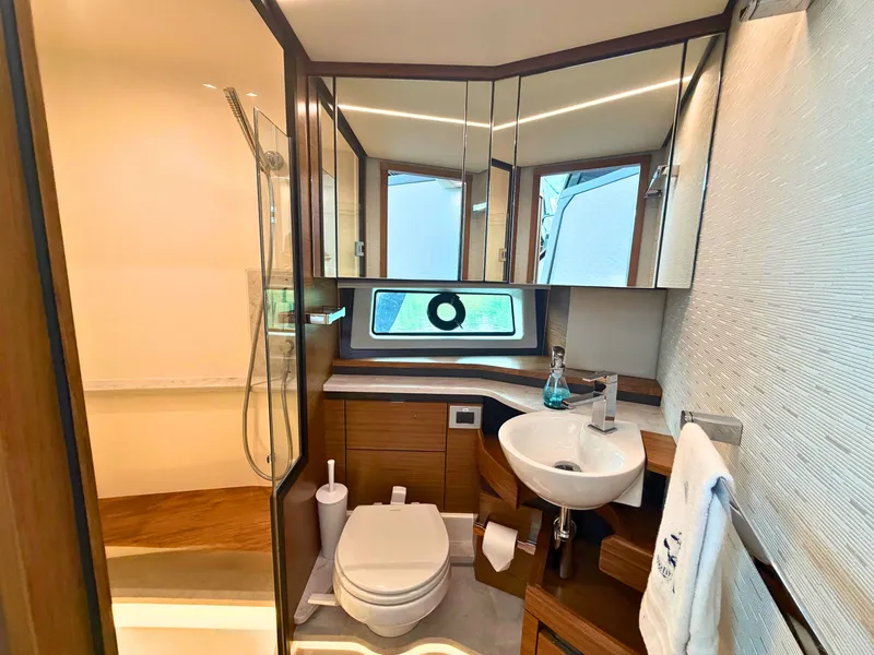 Slide: The Image of Luxurious bathroom with shower, sink, and toilet on a 2025 Tiara Yachts 48 LE. - 30