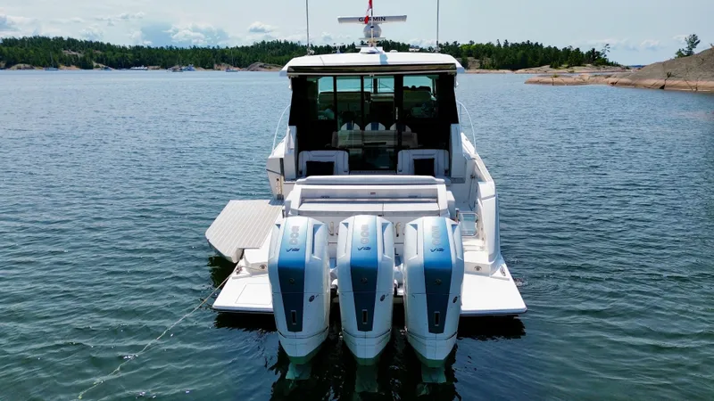 Slide: The Image of The 2025 Tiara Yachts 48 LE is on the water with three outboard engines. - 6