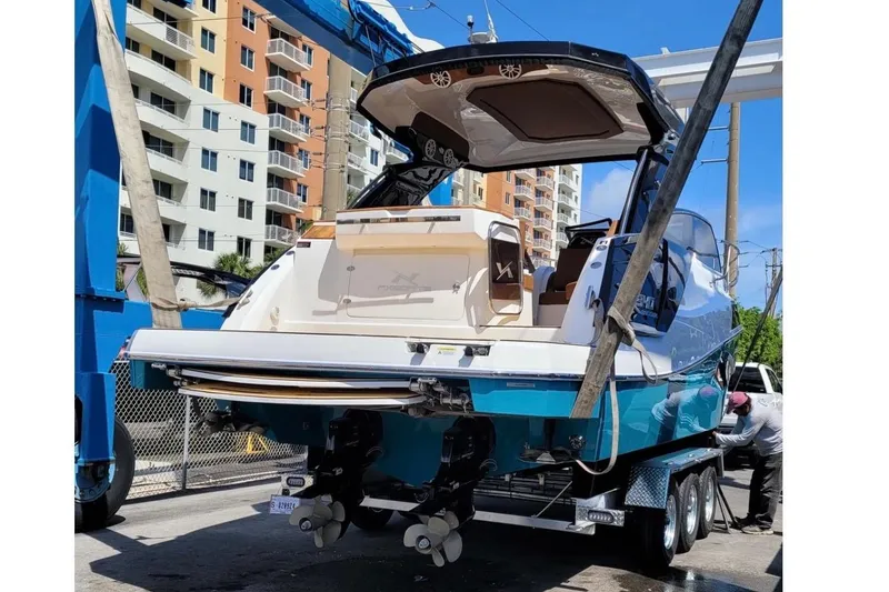 Slide: The Image of The image shows a 2023 NX Boats 340 Sport Coupe on a trailer. - 7