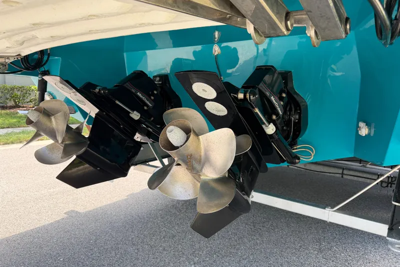 Slide: The Image of 2023 NX Boats 340 Sport Coupe with dual propellers and vibrant blue hull. - 10