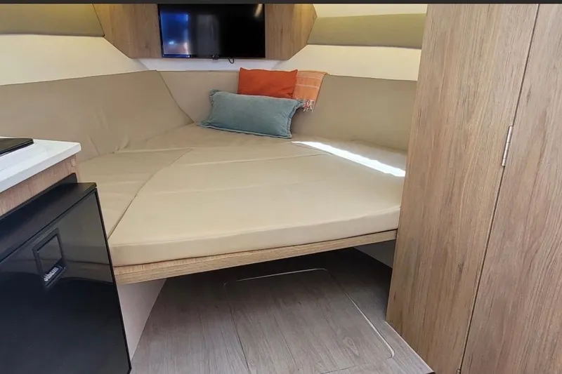 Slide: The Image of Interior cabin of 2023 NX Boats 340 Sport Coupe with cozy seating and modern design. - 22