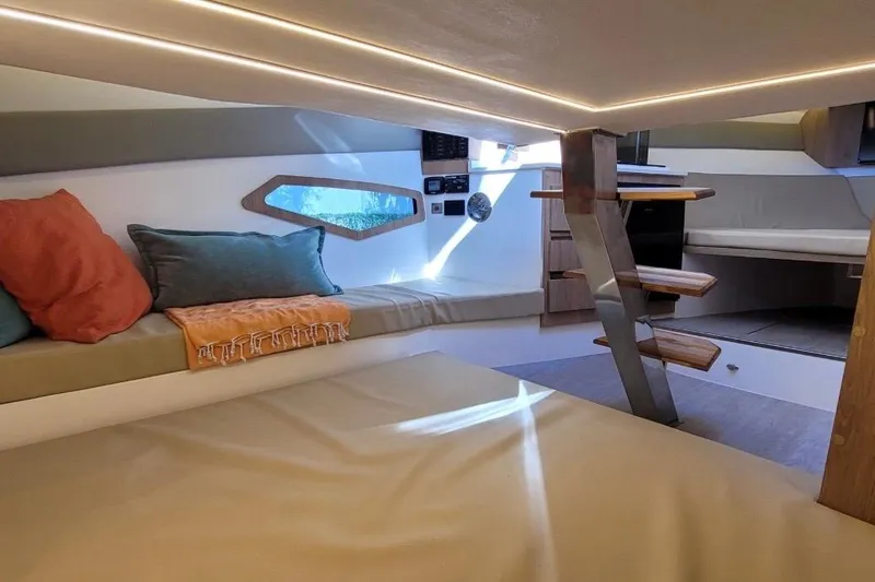 Slide: The Image of Interior of 2023 NX Boats 340 Sport Coupe, featuring cozy seating and modern design. - 26