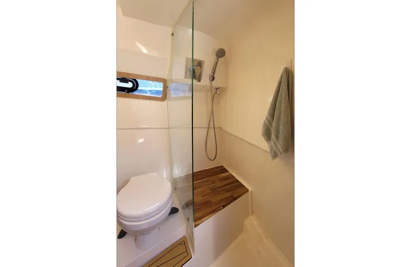 Slide: The Image of Modern bathroom in 2023 NX Boats 340 Sport Coupe with shower and toilet. - 29