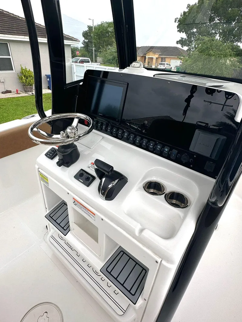 Slide: The Image of 2022 Sea Hunt Ultra 255 SE boat console with steering wheel and controls. - 17
