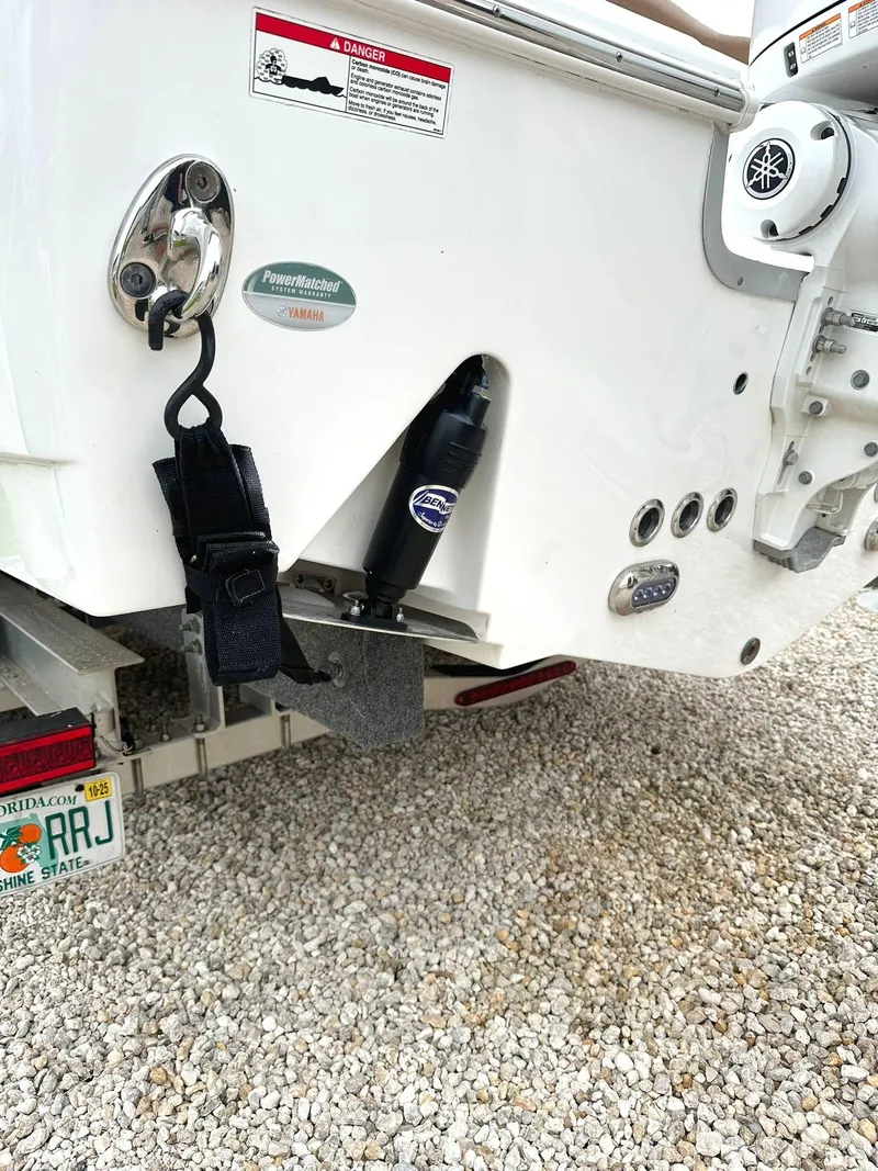 Slide: The Image of 2022 Sea Hunt Ultra 255 SE boat stern with Yamaha components on gravel. - 29