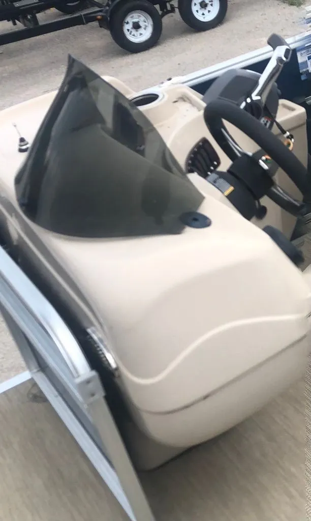 Slide: The Image of The image shows a boat's helm with a steering wheel and windshield. - 5