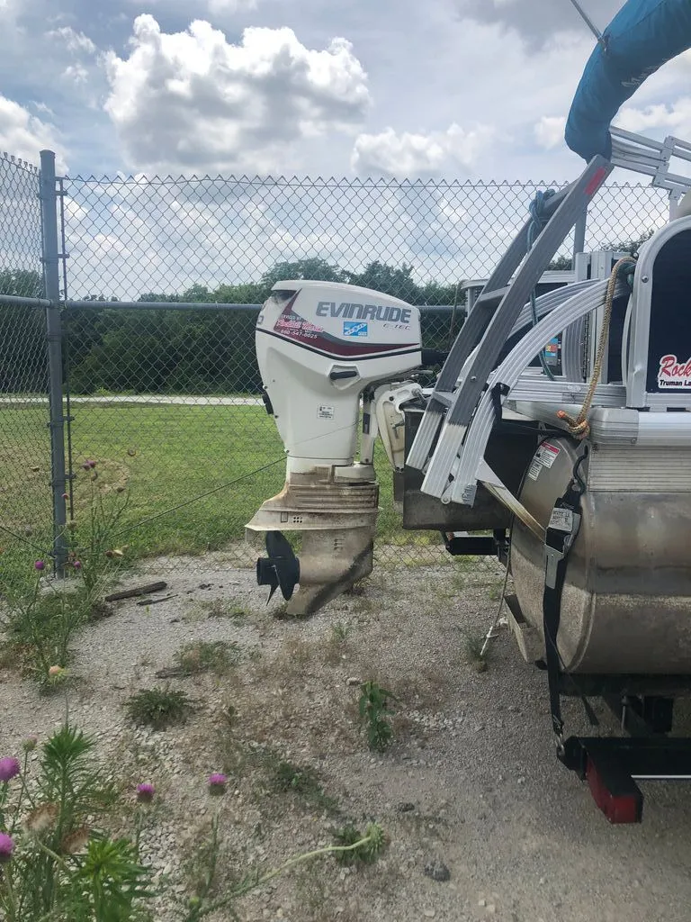 Slide: The Image of An Evinrude outboard motor is attached to a boat on a trailer. - 10