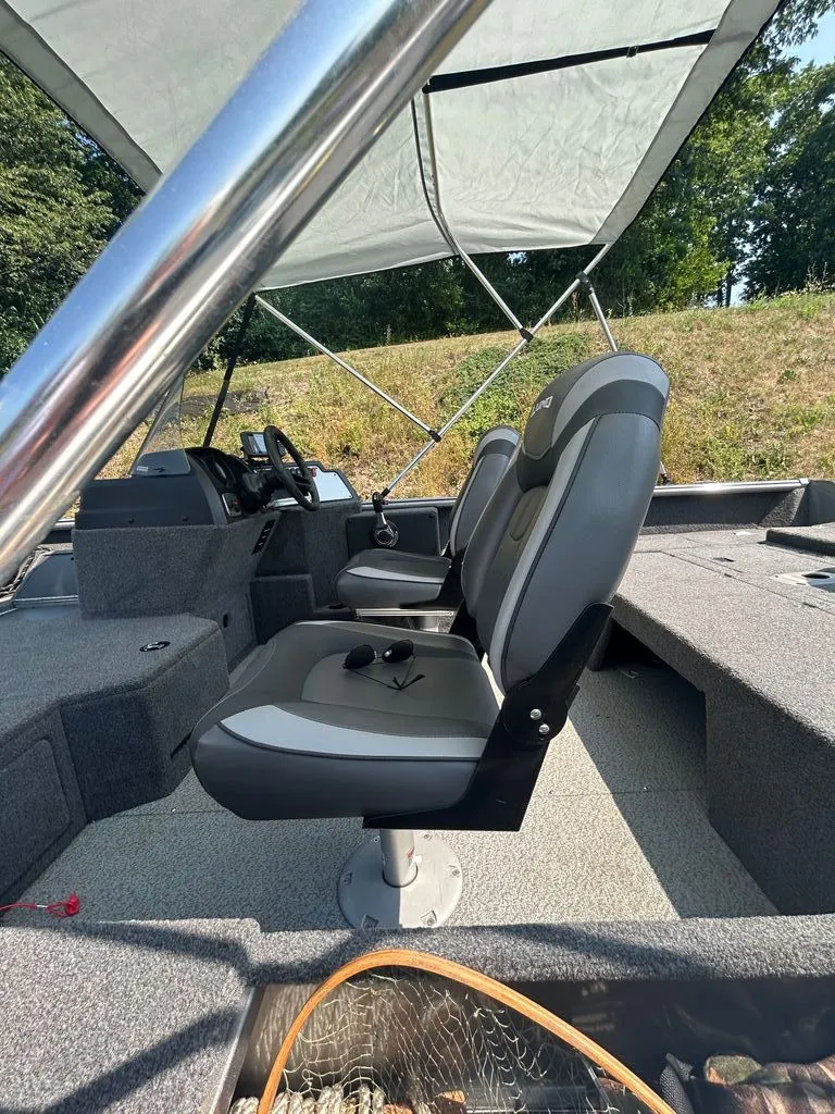 Slide: The Image of Interior view of a 2019 Lund 1675 Impact SS with gray seats and a steering console. - 5