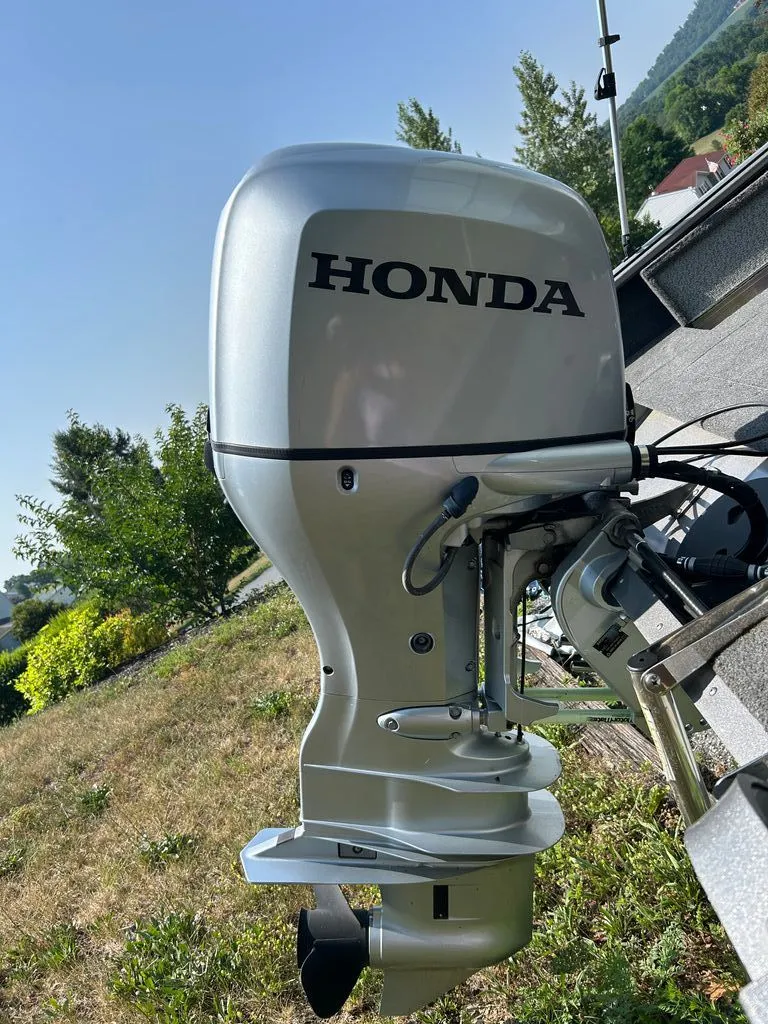 Slide: The Image of A Honda outboard motor attached to a boat on grassy terrain. - 16