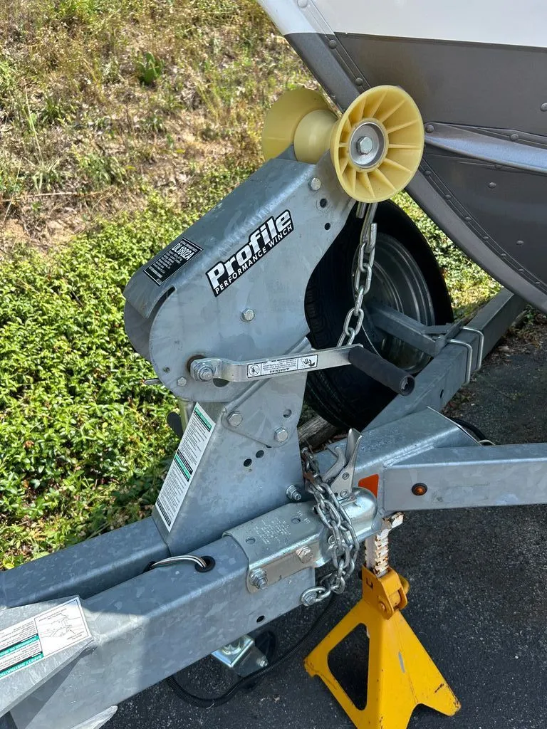 Slide: The Image of Close-up of a boat trailer with a winch and yellow wheel chock. - 19
