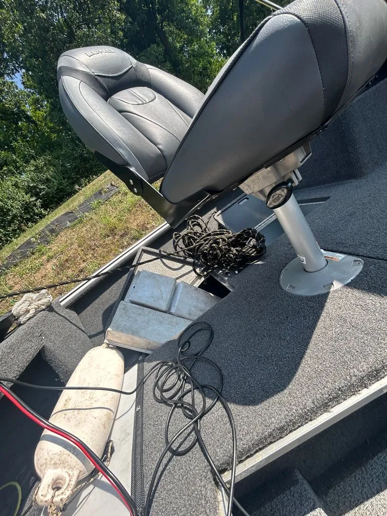 Slide: The Image of A boat with a cushioned seat and fishing gear on the floor. - 8